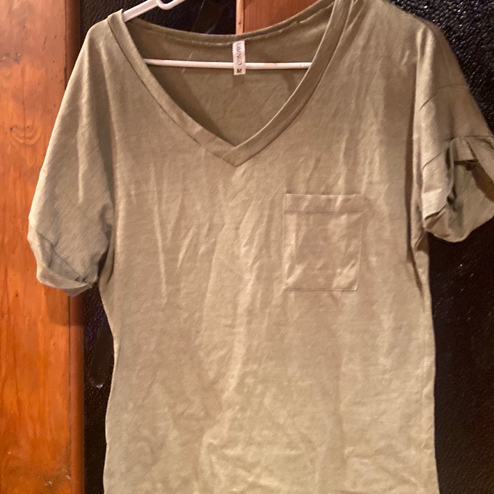 Size medium dark green V-neck T-shirt with a pocket in front. Brand Flamingo